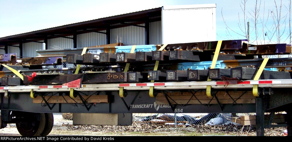 Flatbed load of new ties and rails.